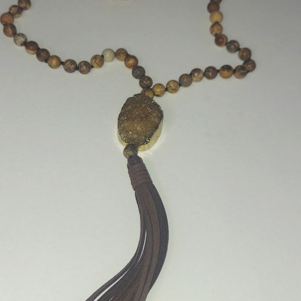 Druzy quartz with wooden bead necklace with faux leather tassel.